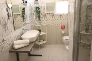 a bathroom with a sink and a toilet at Lùrooms- Guesthouse in Noto in Noto +43 photos