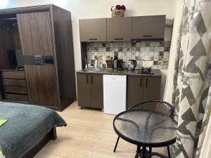 a kitchen with a table and a chair in a room at cosy house in Kobuleti