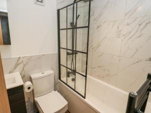 a bathroom with a toilet and a glass shower at Millside View in Keighley +41 photos