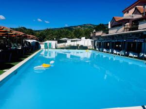 a large blue swimming pool in a resort at Leo's Apartament in Ateleta