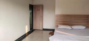 a bedroom with a bed with two white pillows at A R Regency in Mahabaleshwar