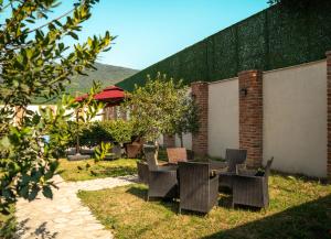a group of chairs and tables in a yard at Hotel Piano Kvareli in Kvareli