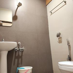 a bathroom with a sink and a toilet at Hotel RK Koramangala in Bengaluru
