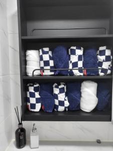 a bunch of towels on a shelf in a bathroom at Gongrim Stay in Seoul +33 photos