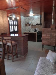 a kitchen with a table and chairs in a room at Edna Cabañas in Tinogasta