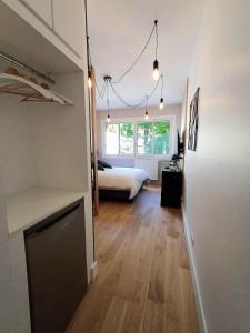a living room with a bed and a bedroom at The Brut Case - Avenue de Champagne in Épernay