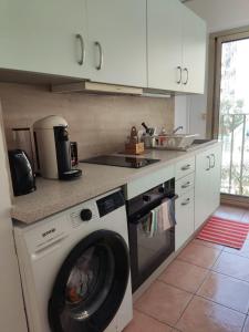 a kitchen with a washing machine in a kitchen at Les Clés d'Or d'Antibes in Antibes +5 photos