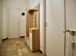a hallway with a bathroom with a sink and a mirror at Brezza di Mar Ligure - casa vacanza in Borghetto Santo Spirito