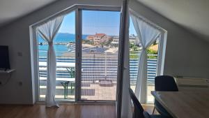 a room with a large window with a view of the ocean at Adriatic Seaview in Petrcane