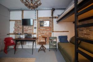 a room with a couch and a table and a bed at Apartament by the cathedral in Lublin