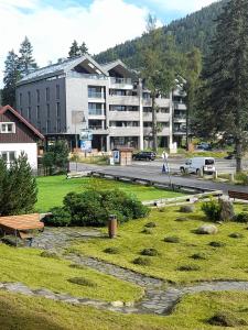 a park with a building in the background and a street at Modern Alpine Apartment Corso Harrachov in Harrachov