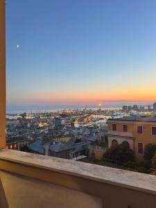 a view of a city at sunset from a balcony at 2SanSiro in Genoa