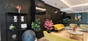 a room with a table and chairs and flowers at Sunday Hevea Hotel and Resort in Angeles