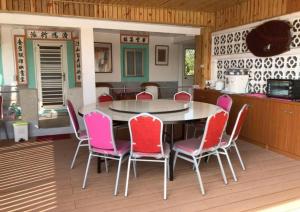 a dining room with a table and pink chairs at Nantang No. 1 in Lieyu