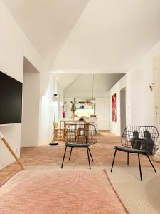 a living room with two chairs and a table at Danna Portuguese Design House Porta 10 in Tavira