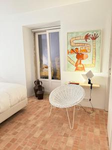 a bedroom with a table and a bed and a table and chair at Danna Portuguese Design House Porta 10 in Tavira