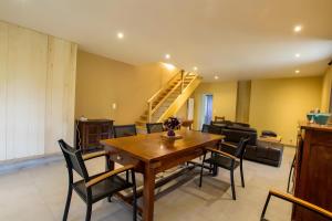 a dining room with a wooden table and chairs at Charmante maison piscine privée in Siorac-en-Périgord