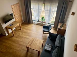 a living room with a couch and a table at Ferienwohnung Pferdehof Birkholz in Bernau bei Berlin