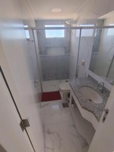 a bathroom with a shower and a sink and a toilet at Spectacular apartment 202C - 7 thermal pools in Caldas Novas