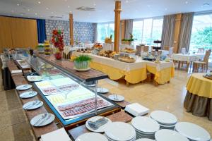 a buffet of food on display in a restaurant at Hotel Kimen - Annex in Cres