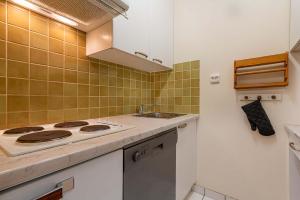 a kitchen with a stove and a sink at Residence Hauts de Chaviere In Val Thorens, Ski In-Out with WiFi in Val Thorens