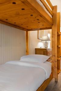 a bedroom with a large bed with white sheets at Residence Hauts de Chaviere In Val Thorens, Ski In-Out with WiFi in Val Thorens