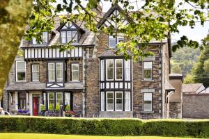 a large brick house with black and white windows at Finest Retreats - Kelsick Villa Guest House - Helvellyn in Ambleside