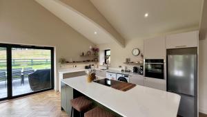 a kitchen with a sink and a counter top at Easter Kincaple Garden Cottage in Guard Bridge +13 photos