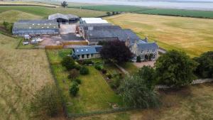 an aerial view of a large house in a field at Easter Kincaple Garden Cottage in Guard Bridge