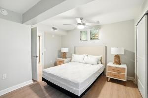a white bedroom with a bed and two night stands at Lighthouse Resort & Club in Sanibel