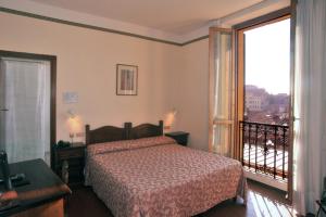 Ein Bett oder Betten in einem Zimmer der Unterkunft Hotel Priori