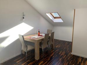 a dining room with a table with chairs and a window at Nice apartment near Orio airport in Trezzano Rosa