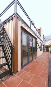 a building with a glass door and a staircase at Bee Home Di Linh in Di Linh +5 photos