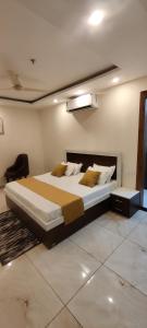 a bedroom with a large bed in a room at Hotel Hiltane in Kharar