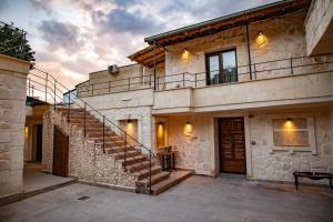a building with a staircase on the side of it at Senior Stone House in Nevsehir