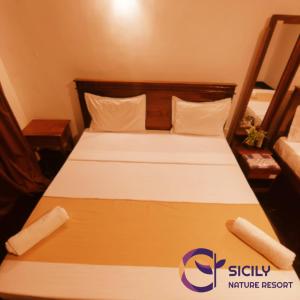 Rúm í herbergi á Sicily Nature Resort