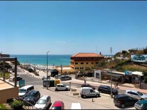 a lot of cars parked in a parking lot next to the ocean at Heart Stone by the Sea in Lourinhã +13 photos
