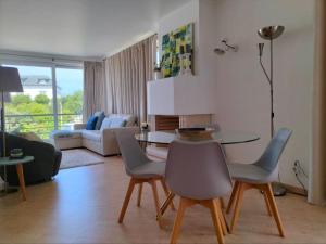 a living room with a table and chairs at Heart Stone by the Sea in Lourinhã