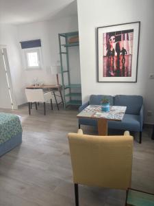 a living room with a couch and a table at O Tourinho Ferrel in Ferrel