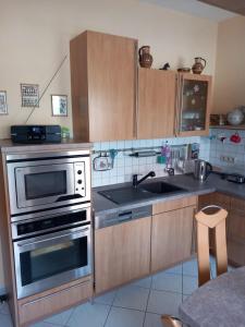 a kitchen with a stainless steel oven and a sink at Harz und Gemütlich in Blankenburg