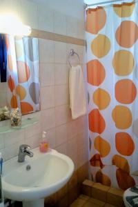 a bathroom with a sink and a shower curtain at Vigles in Adamantas +37 photos