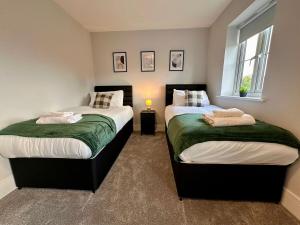 Voodi või voodid majutusasutuse Stunning 4 Bedroom, Sleeps 9, Centre Of Telford toas