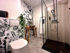 a bathroom with a toilet and a shower at Meuse Cottage in Hastière-par-delà