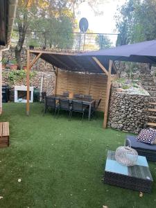 a patio with a table and chairs under a canopy at Su Paraiso in Fréjus