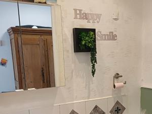 a bathroom with a window and a plant on the wall at l'Escale Côtière in Boulogne-sur-Mer +16 photos