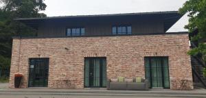 a brick building with a couch in front of it at MotelplusHotel BiggeSeeFront in Olpe