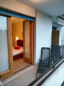 a balcony with a room with a bed and a chair at Residence Florida B03 - a 200m dal lungolago - in Lazise +94 photos