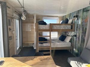 a small room with two bunk beds in it at Hébergement Parc du Mont Saint-Mathieu in Saint Mathieu de Rioux