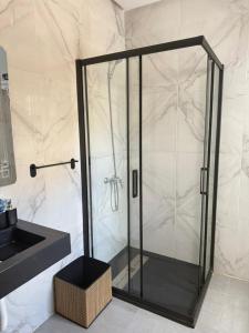 a glass shower in a bathroom with a sink at Luxury Appart à louer - Mdiq in M'diq +7 photos