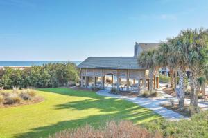 a house with a large yard with palm trees at Elegant 3 BR 3 BA Wild Dunes Gated Resort Villa with 2 Golf Courses, Beach and Pool in Isle of Palms